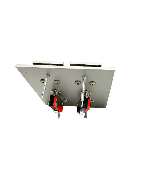 Rear view of a dual push button switch assembly with metal plate, mounting bolts, and exposed wiring terminals